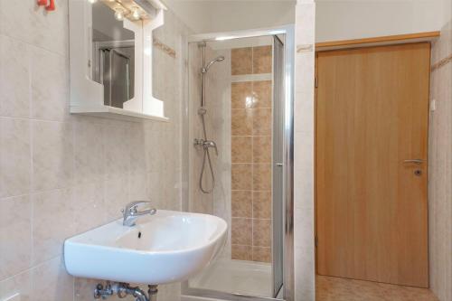 a bathroom with a sink and a shower at APARTMAJI PRI BOSI NOGI in Izola