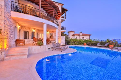 a swimming pool in front of a house at Hill House Adult Only in Kaş