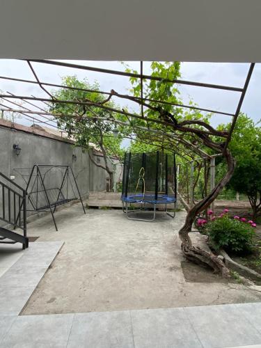 a playground in a yard with a swing at Vernatoon Guest House in Vagharshapat
