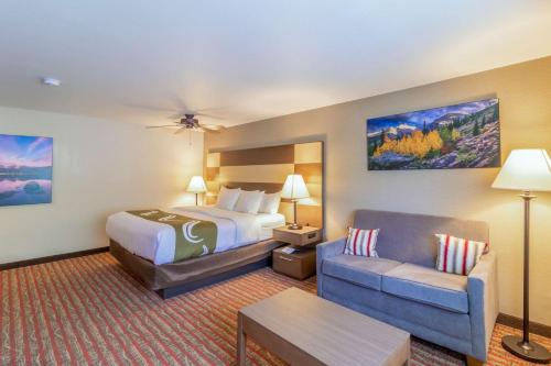 a hotel room with a bed and a couch at Quality Inn near Rocky Mountain National Park in Estes Park