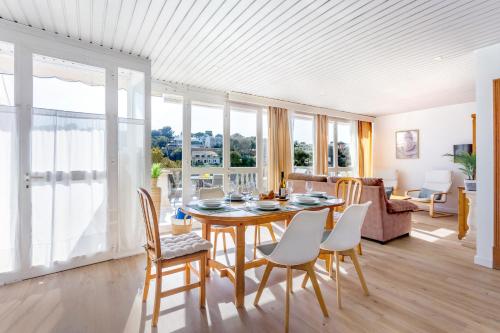 a dining room with a table and chairs at Apartamentos Drac by dracmallorca in Cala Santanyi