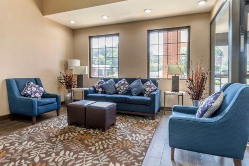 a living room with blue couches and windows at Comfort Inn in Marion