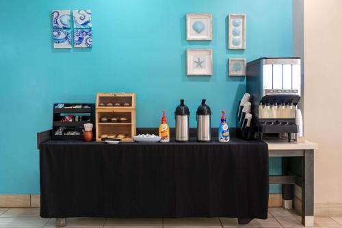 a table with bottles of wine on a blue wall at Wyndham Corpus Christi Resort North Padre Island in Corpus Christi