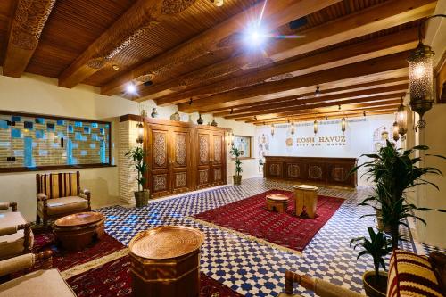 a large room with a bar with a table at Kosh Havuz boutique hotel in Samarkand