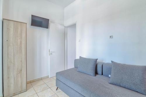 a living room with a couch and a flat screen tv at Pavlos Place in Antiparos Town
