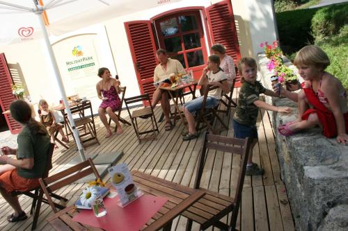 a group of children sitting in chairs on a deck at HolidayPark Mlázovy in Kolinec