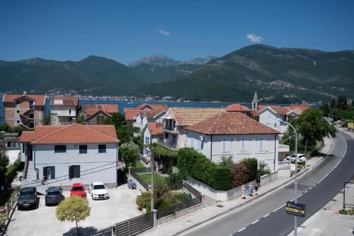 a town with houses and a road and mountains at Tivat TOP privacy apartments Manor in Tivat