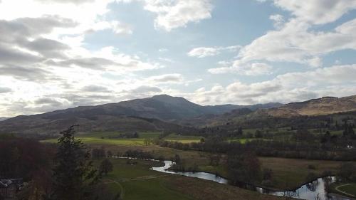 a view of a valley with a river and mountains at Westmains Lodge in Callander