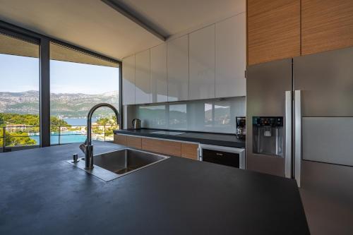 a kitchen with a sink and a large window at Korcula Hill in Korčula