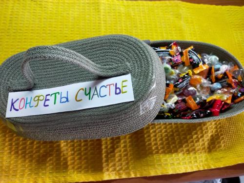 a container of candy in a yellow cloth at Аэропорт 5 минут in Prigorodnyy