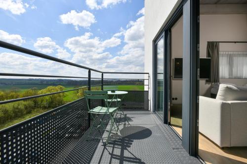 a balcony of a house with a table and a couch at ibis Styles Namur in Namur
