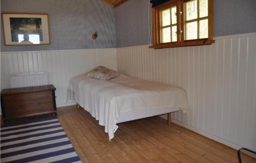 a small bedroom with a bed and a window at Cozy Home In Långserud With Jacuzzi in Rullan