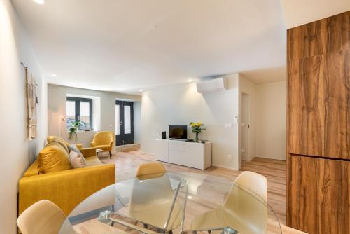 a living room with a couch and a table at São Sebastião Apartment By Sé Apartamentos in Braga