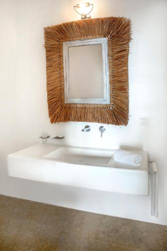 a bathroom with a white sink and a mirror at Liberation Villa in Kalafatis