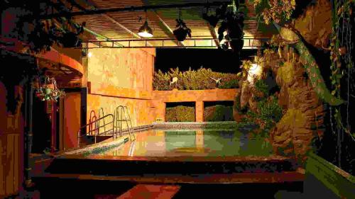 a building with a courtyard with a pond in it at Parklane Hotel in Mysore