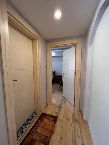 a hallway with two wooden doors and a floor at My Home Hotel Gulluk in Antalya
