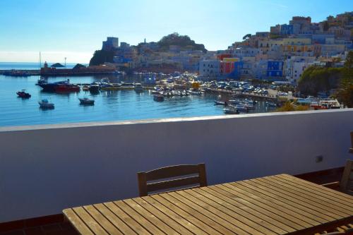 a balcony with a table and a view of a harbor at Maridea - Spiaggia Sant' Antonio in Ponza