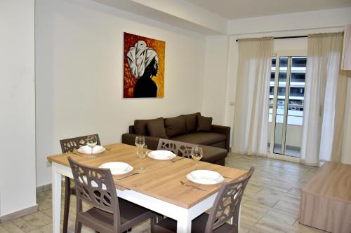 a dining room with a table and a couch at SGC Boa Vista Apartments in Sal Rei
