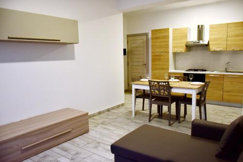 a kitchen and dining room with a table and chairs at SGC Boa Vista Apartments in Sal Rei