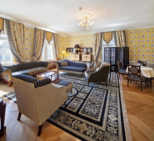 a living room with couches and a rug at The Bonerowski Palace in Krakow