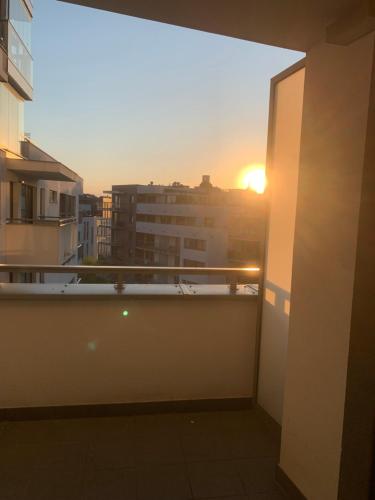 a view of the sunset from the balcony of a building at Forest Apart III in Warsaw