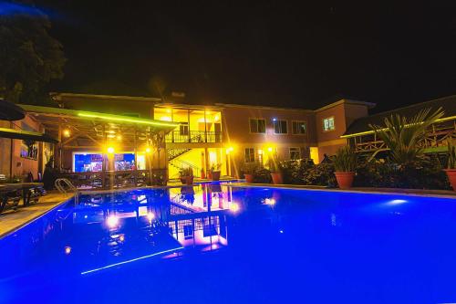 a swimming pool at night with blue lights at The Okaseni Lodge in Arusha