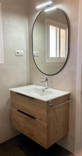 a bathroom with a sink and a mirror at Residentie Montesol in Torrox