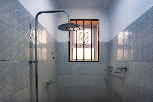 a bathroom with a shower and a window at The Okaseni Lodge in Arusha