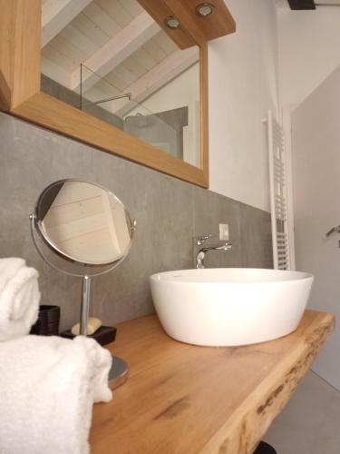 a bathroom with a sink and a mirror on a counter at appartamenti Residenza 1928 in Tremosine Sul Garda