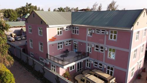 an overhead view of a pink building with a parking lot at The Okaseni Lodge in Arusha