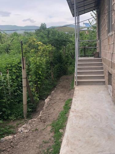 a stairway leading up to a building with a set of stairs at Norik guest house in Garni