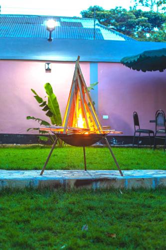 a lighted table in the grass in a yard at The Okaseni Lodge in Arusha