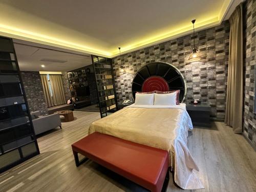 a bedroom with a large bed and a brick wall at Song Xia Motel in Dali