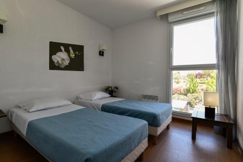 Ένα ή περισσότερα κρεβάτια σε δωμάτιο στο Domaine de Saint Orens - Résidence de vacances - Montréal du Gers