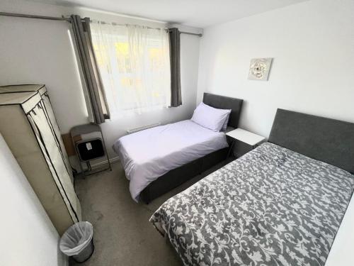 a small bedroom with two beds and a window at Cheerful Heeley Home in Heeley