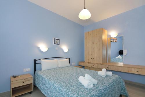 a bedroom with a bed with two towels on it at Agapitos Apartments in Nikiti