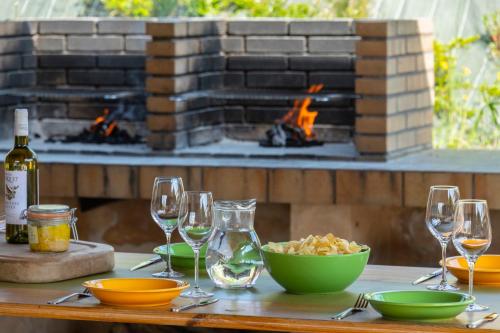 a table with wine glasses and a bowl of food and a fireplace at Vacancéole - Domaine de Saint Orens in Montréal