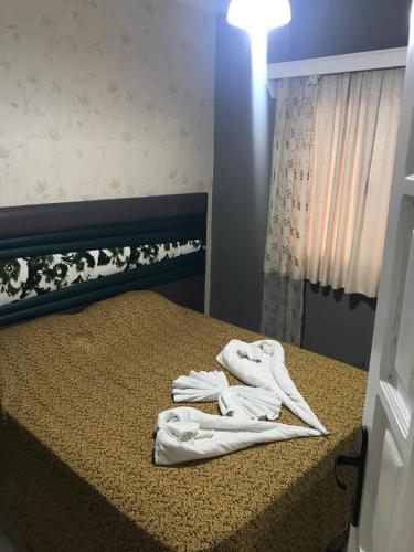 a pair of white towels sitting on top of a bed at HİMEROS BEACH HOTEL in Kemer