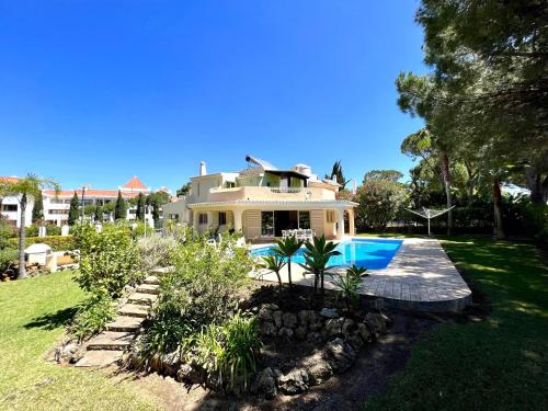 a house with a swimming pool in a yard at Vilamoura Amazing Golf Villa With Pool by Homing in Vilamoura