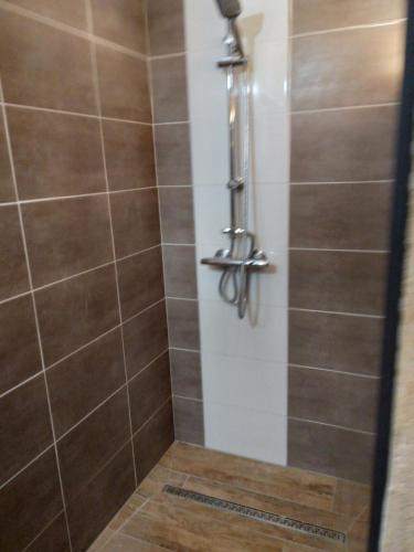 a shower with a tiled floor and a shower at viarhona in Montélimar