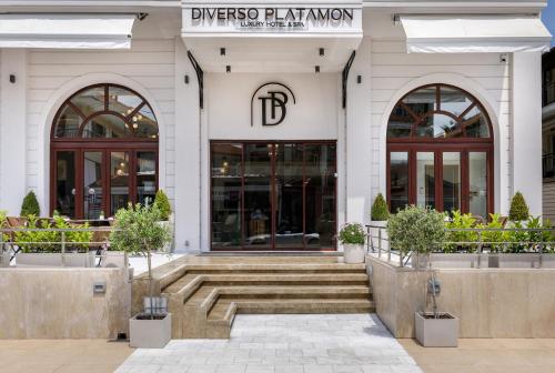 a building with a staircase in front of it at Diverso Platamon, Luxury Hotel & Suites in Platamonas