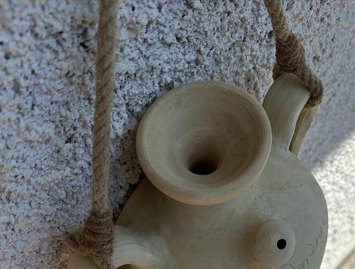 a white vase sitting next to a wall at La Terrazza in Sapri