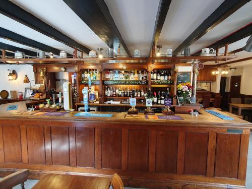 a bar in a pub with a lot of alcohol at The Ship Inn in Truro