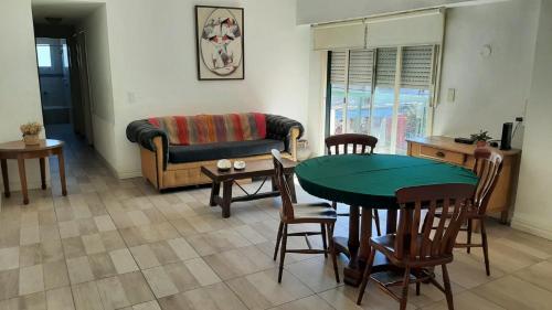 sala de estar con mesa, sillas y sofá en Apartamento en Pilar centro en Pilar