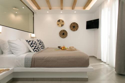 a bedroom with a bed and a tv on the wall at Villa Jardin De Stelida in Stelida