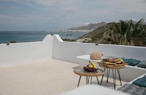 a balcony with a table with fruit on it at Villa Jardin De Stelida in Stelida