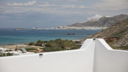 a view of the ocean from a white building at Villa Jardin De Stelida in Stelida