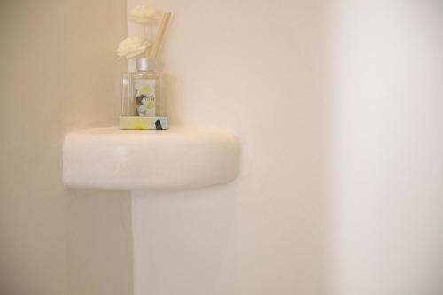 a bathroom sink with a vase of flowers on it at Villa Jardin De Stelida in Stelida
