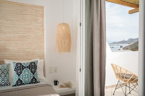 a bedroom with a bed and a view of the ocean at Villa Jardin De Stelida in Stelida