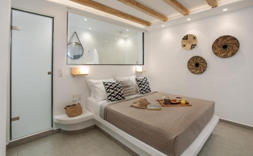 a bedroom with a bed with a tray of fruit on it at Villa Jardin De Stelida in Stelida